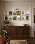 Wall with framed pictures of Jared VanderMeer 2026 Wildlife Collector Set above a wooden sideboard in a room.